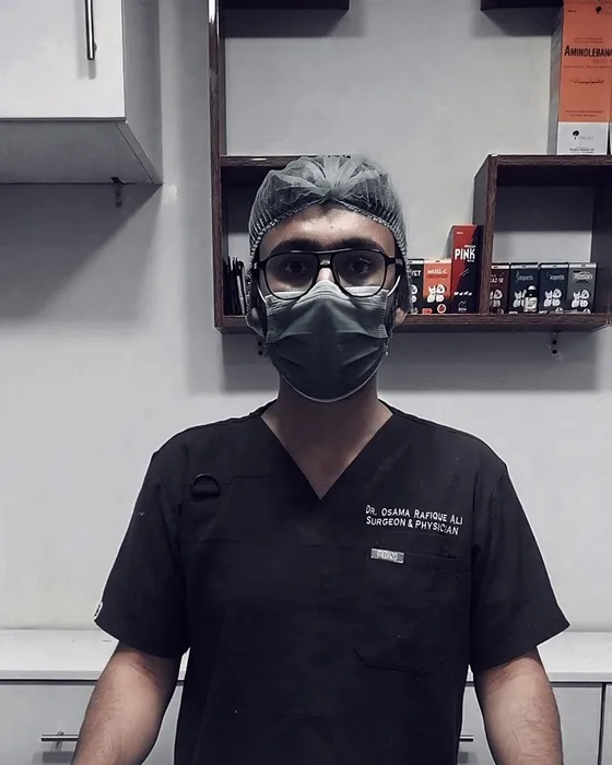 A Petchester Animal Clinic vet in black scrubs, surgical cap and mask