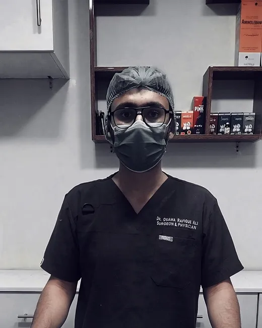 A Petchester Animal Clinic vet in black scrubs, surgical cap and mask