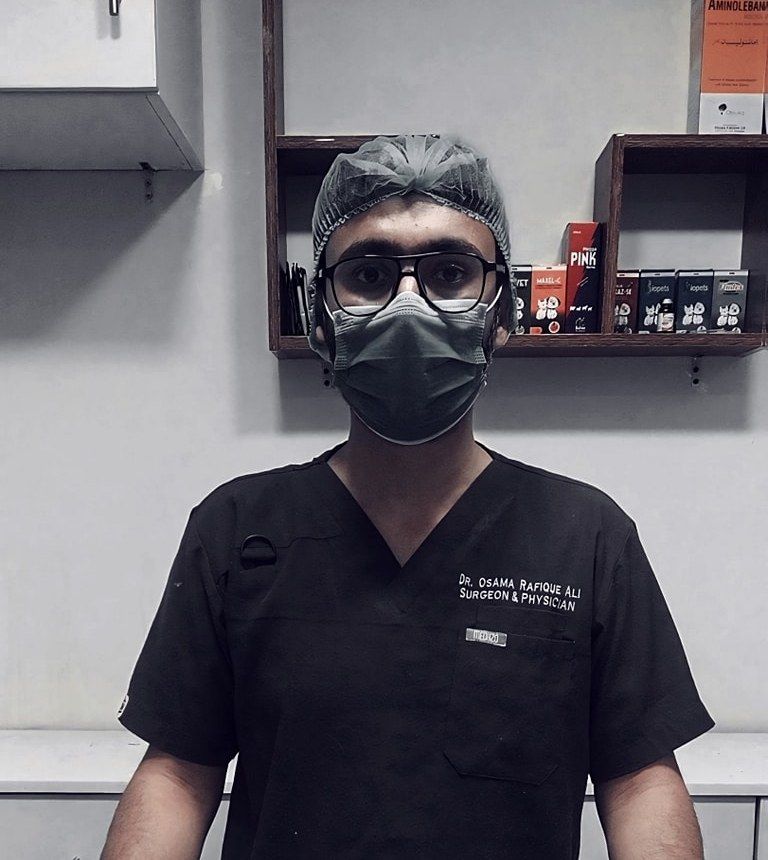 A Petchester Animal Clinic vet in black scrubs, surgical cap and mask at the clinic